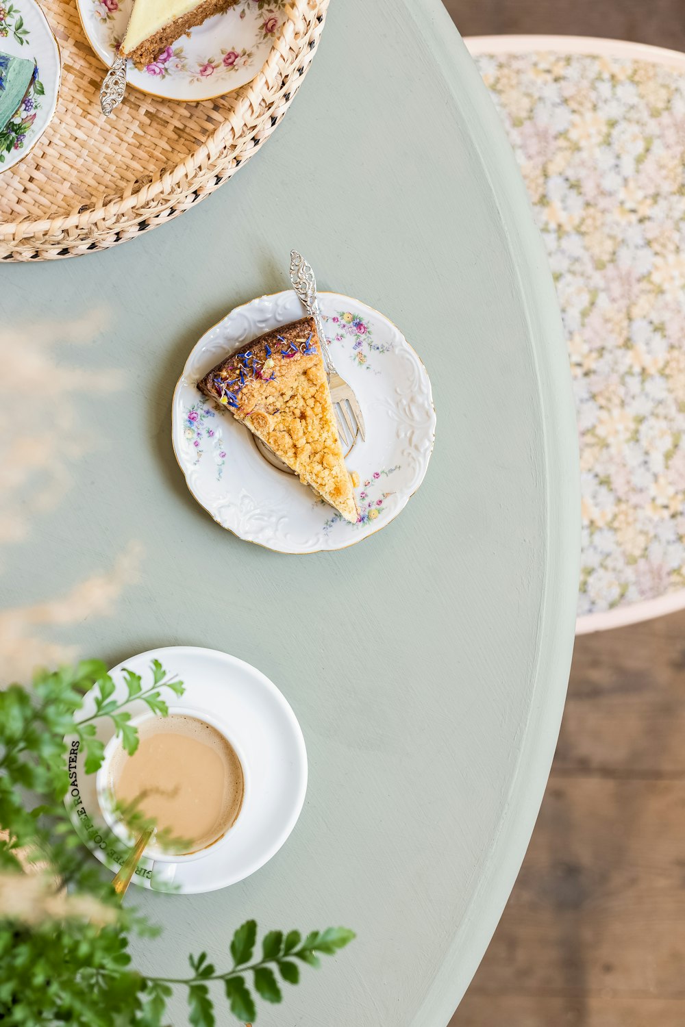 a slice of cake on a plate next to a cup of coffee