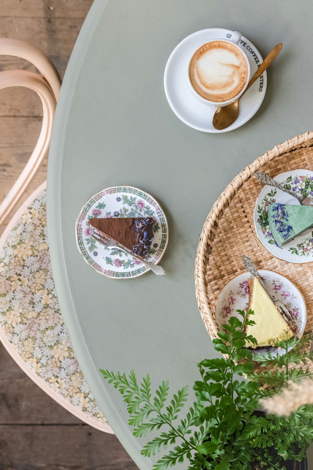 a table topped with plates of food and a cup of coffee