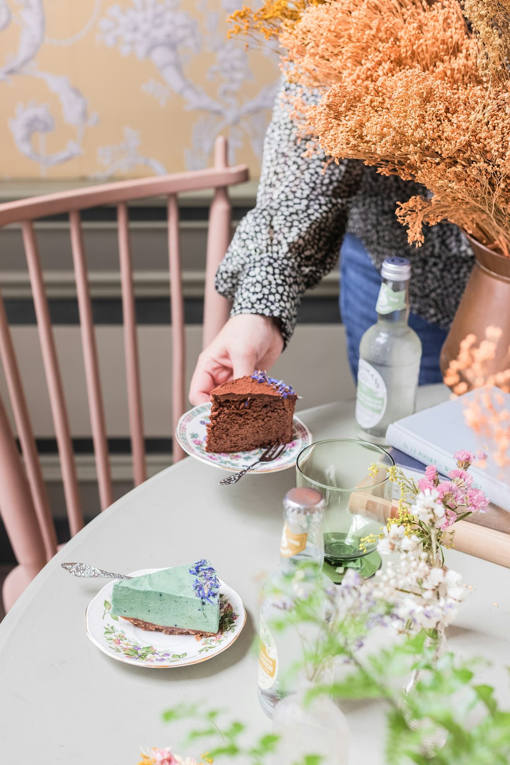 a person is holding a piece of cake on a plate