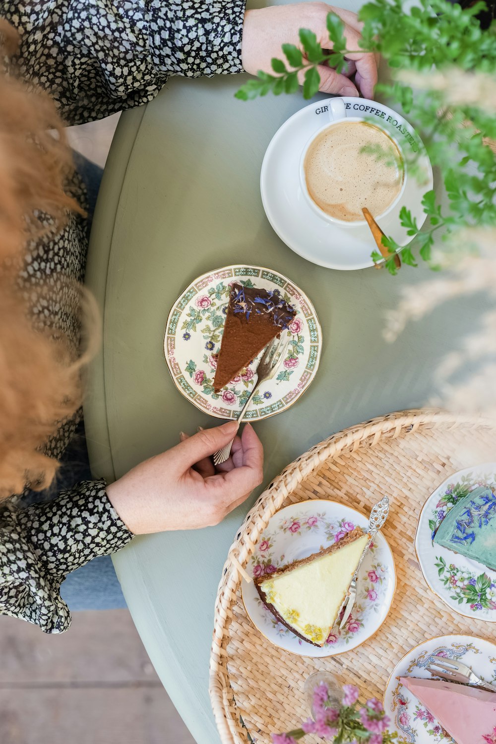 a person sitting at a table with a piece of cake