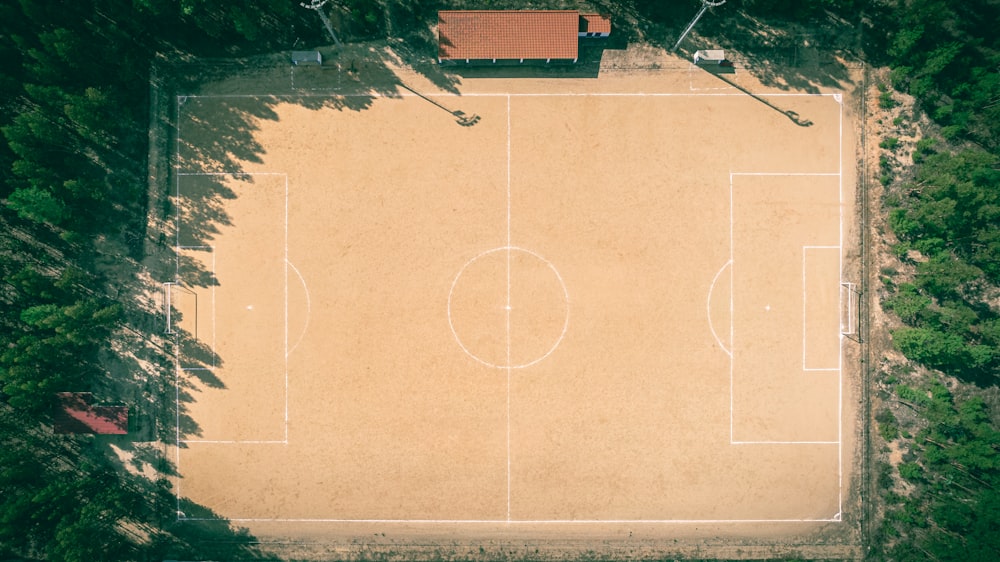 an aerial view of a basketball court surrounded by trees