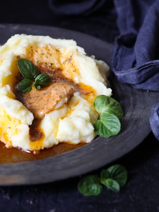 a plate of mashed potatoes topped with gravy