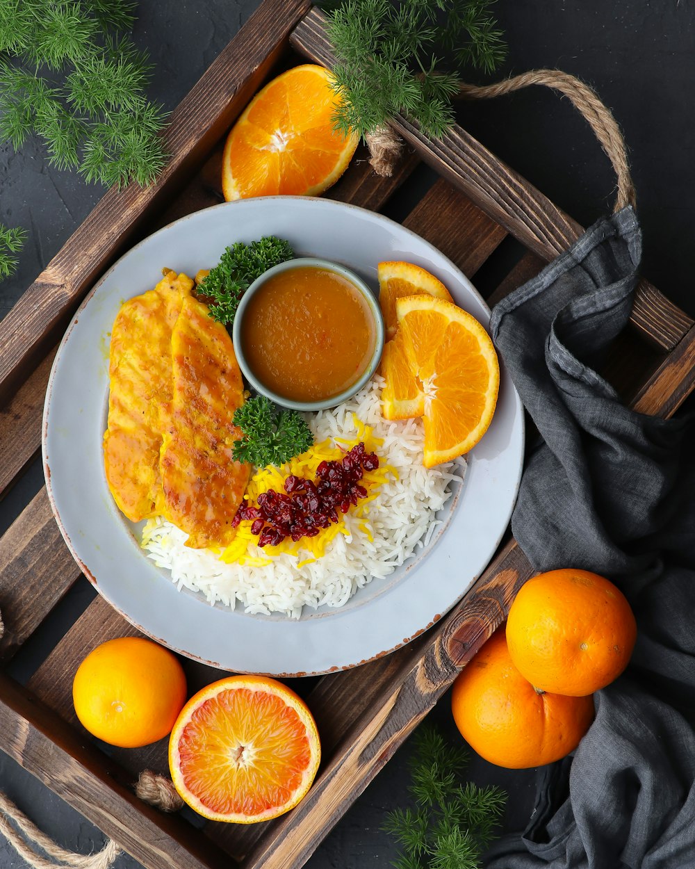 a white plate topped with rice and oranges