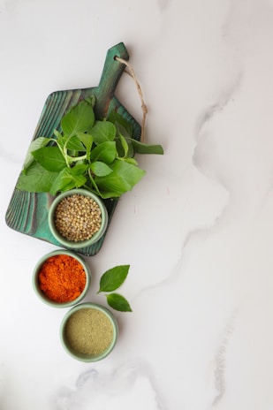 a table topped with bowls filled with different types of spices