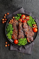 a plate of meat and vegetables on a table