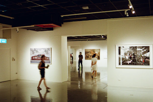 Visitors walking through an art museum gallery