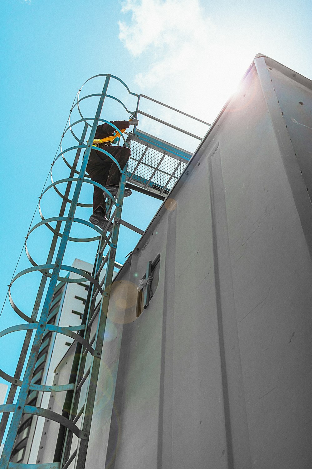 a man on a scaffold working on the side of a building