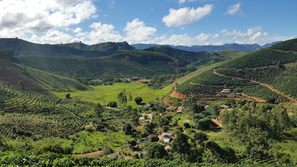 a lush green valley surrounded by mountains