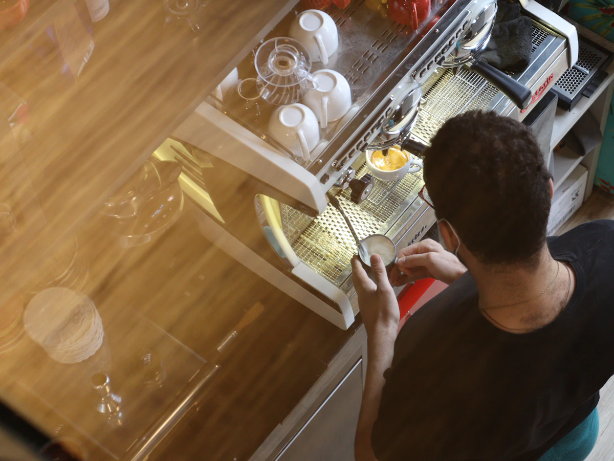 Technician checking a dishwasher during a drain-fault diagnosis