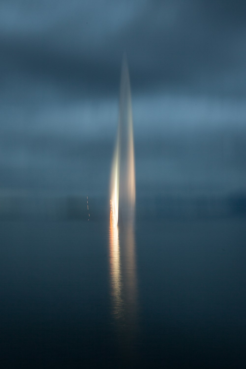 a long exposure photo of a light emitting out of the water
