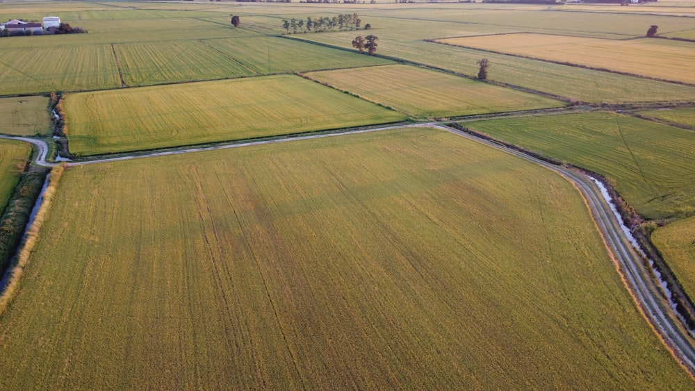 an aerial view of a large field with a road running through it