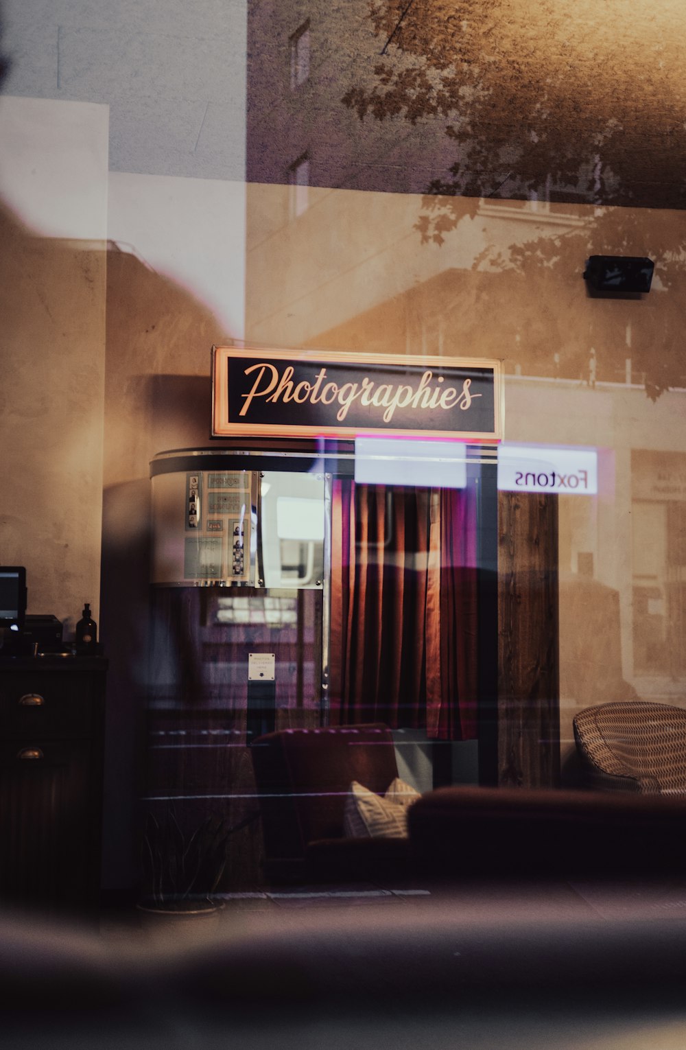 a reflection of a photographer's shop in a window