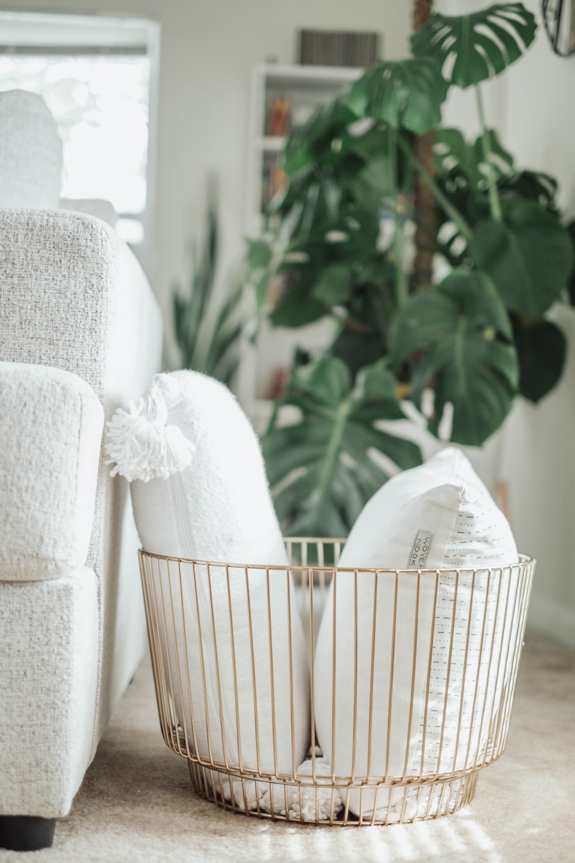a white chair and a basket on the floor