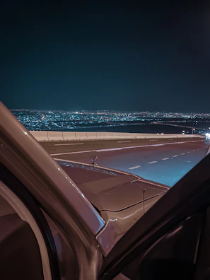 Wide shot of the city skyline at dawn with a Lumina model gazing out, embodying the active urban spirit