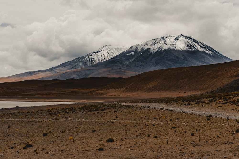 a mountain range with a body of water in the foreground