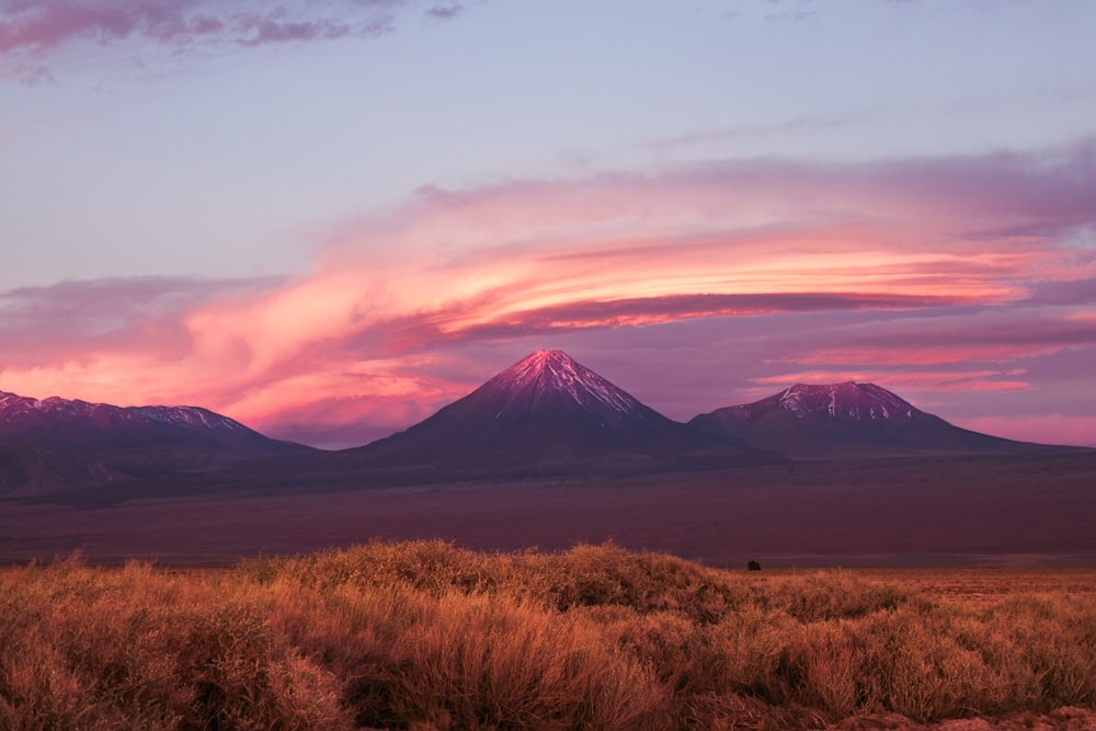 a sunset view of a mountain range in the distance