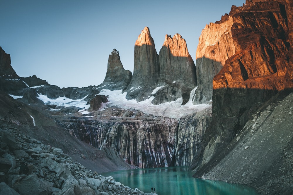 a mountain range with a lake in the foreground