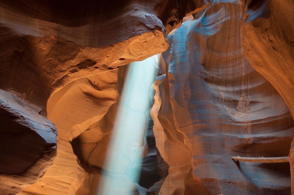 a light shines through a narrow slot in a canyon
