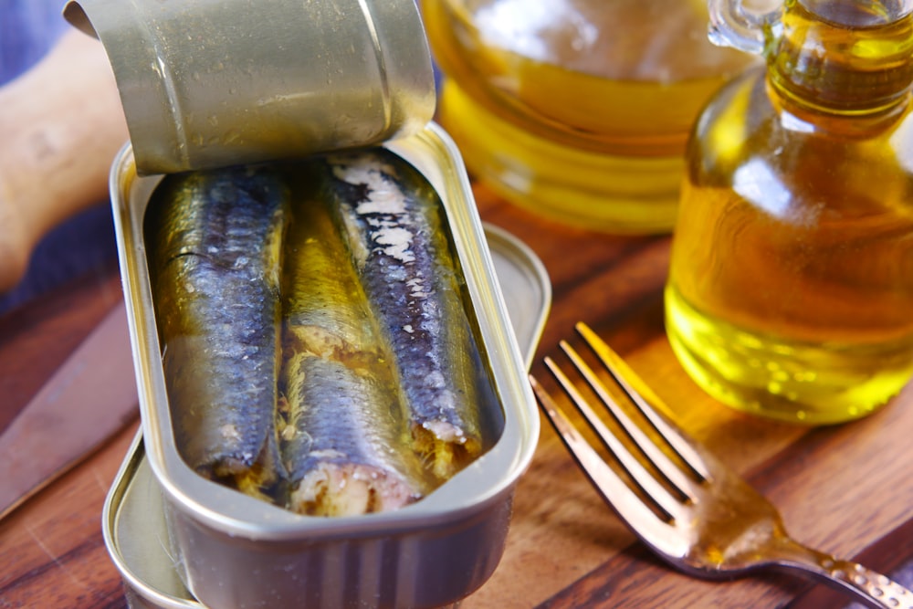 a tin of sardines sitting on top of a wooden table
