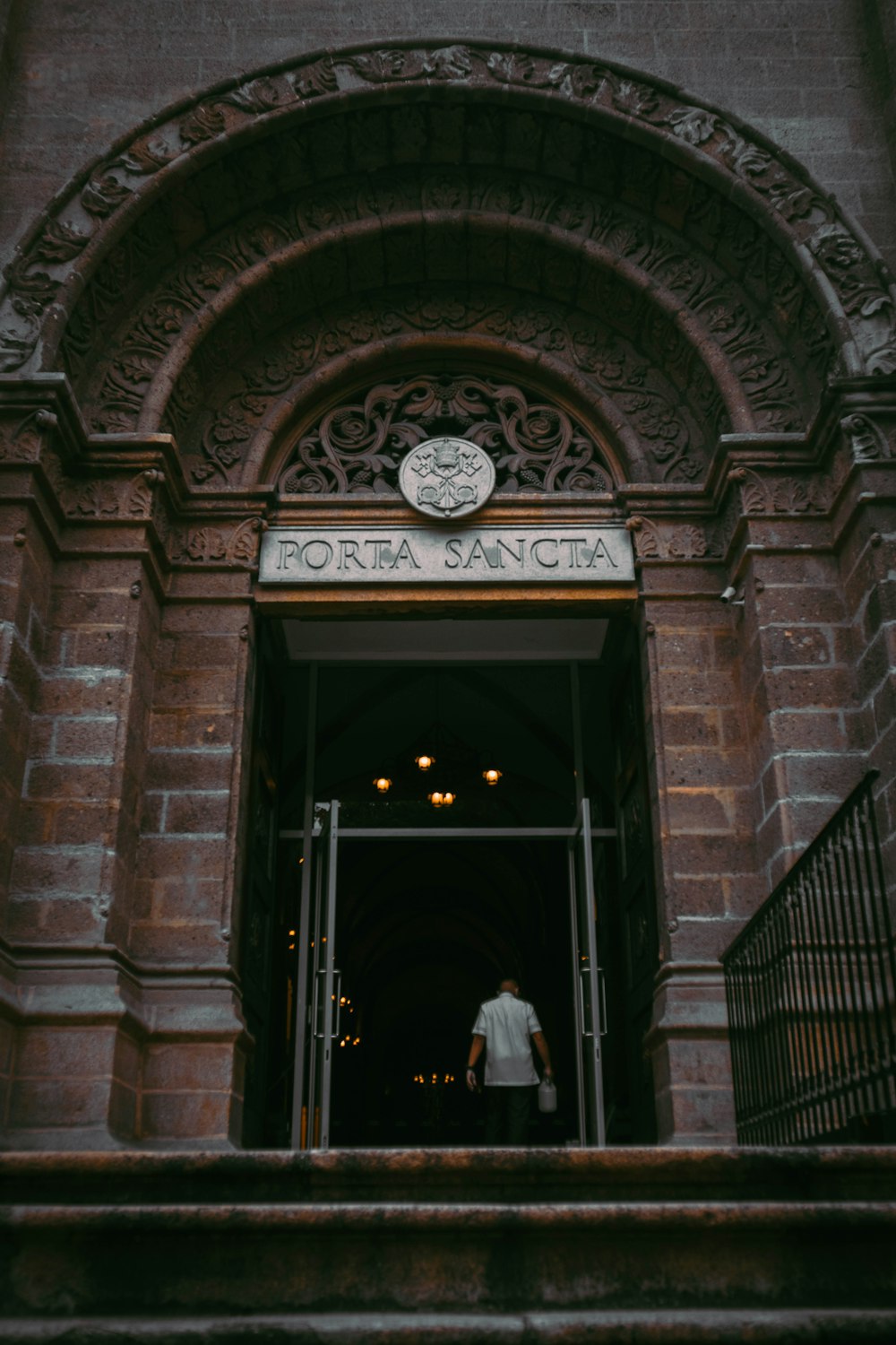 a man walking out of a doorway into a building