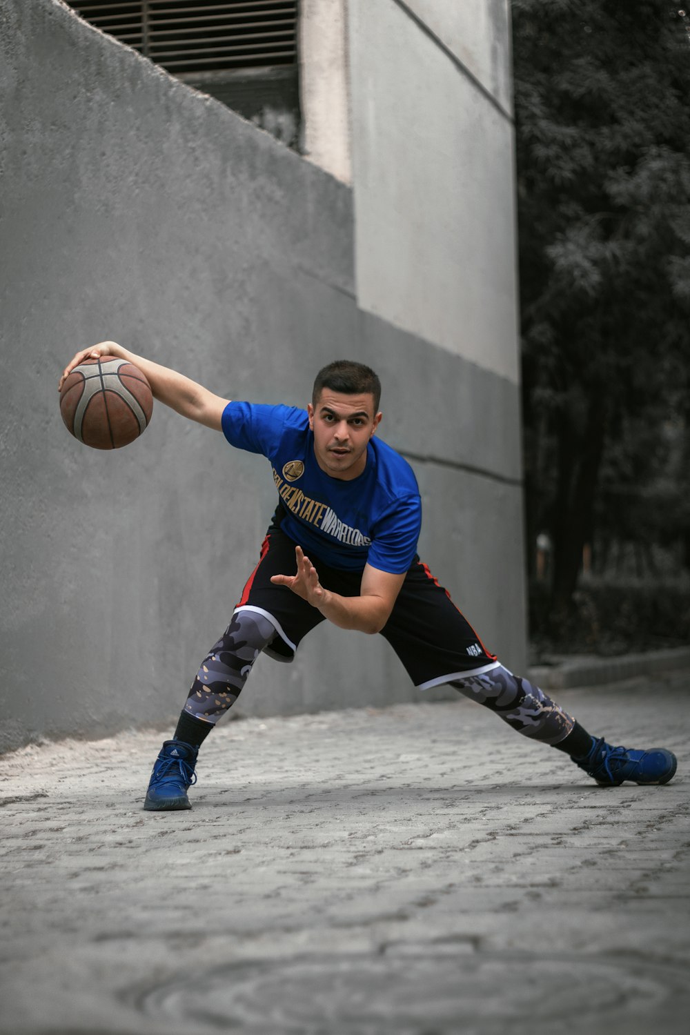 a man holding a basketball in his right hand