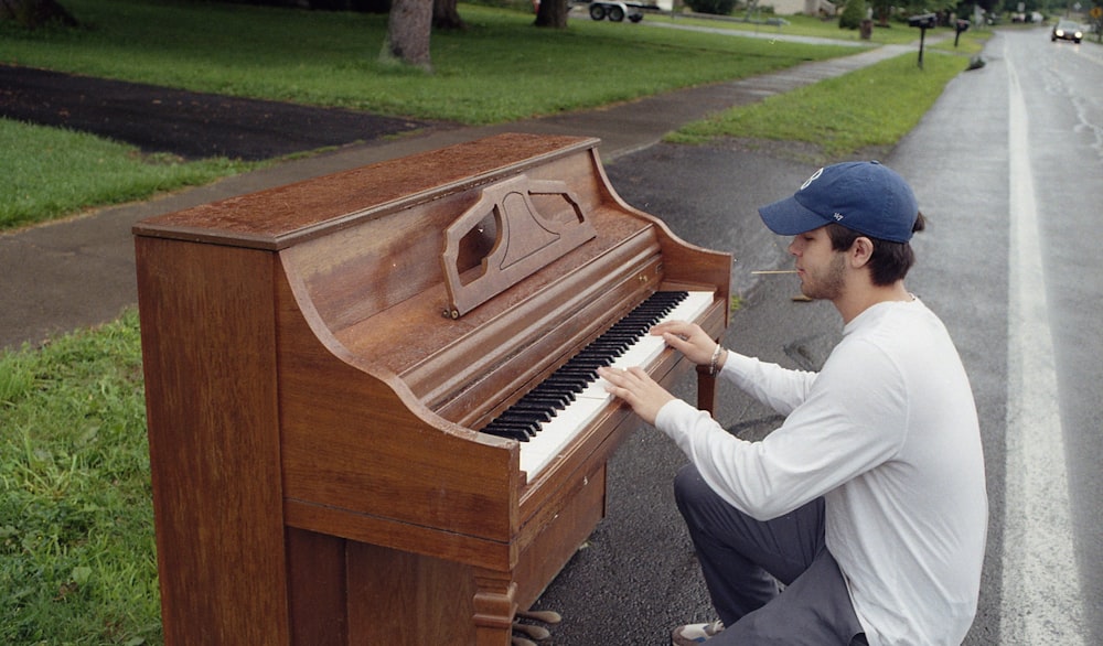 a man playing a piano on the side of the road