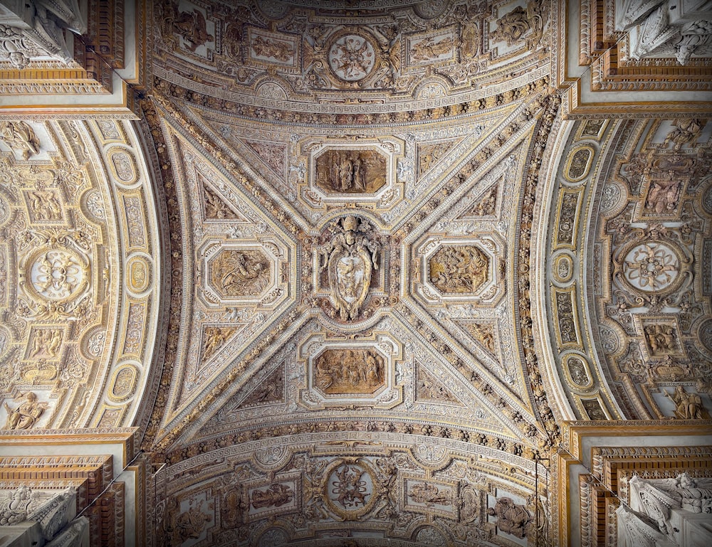 the ceiling of a building with intricate designs