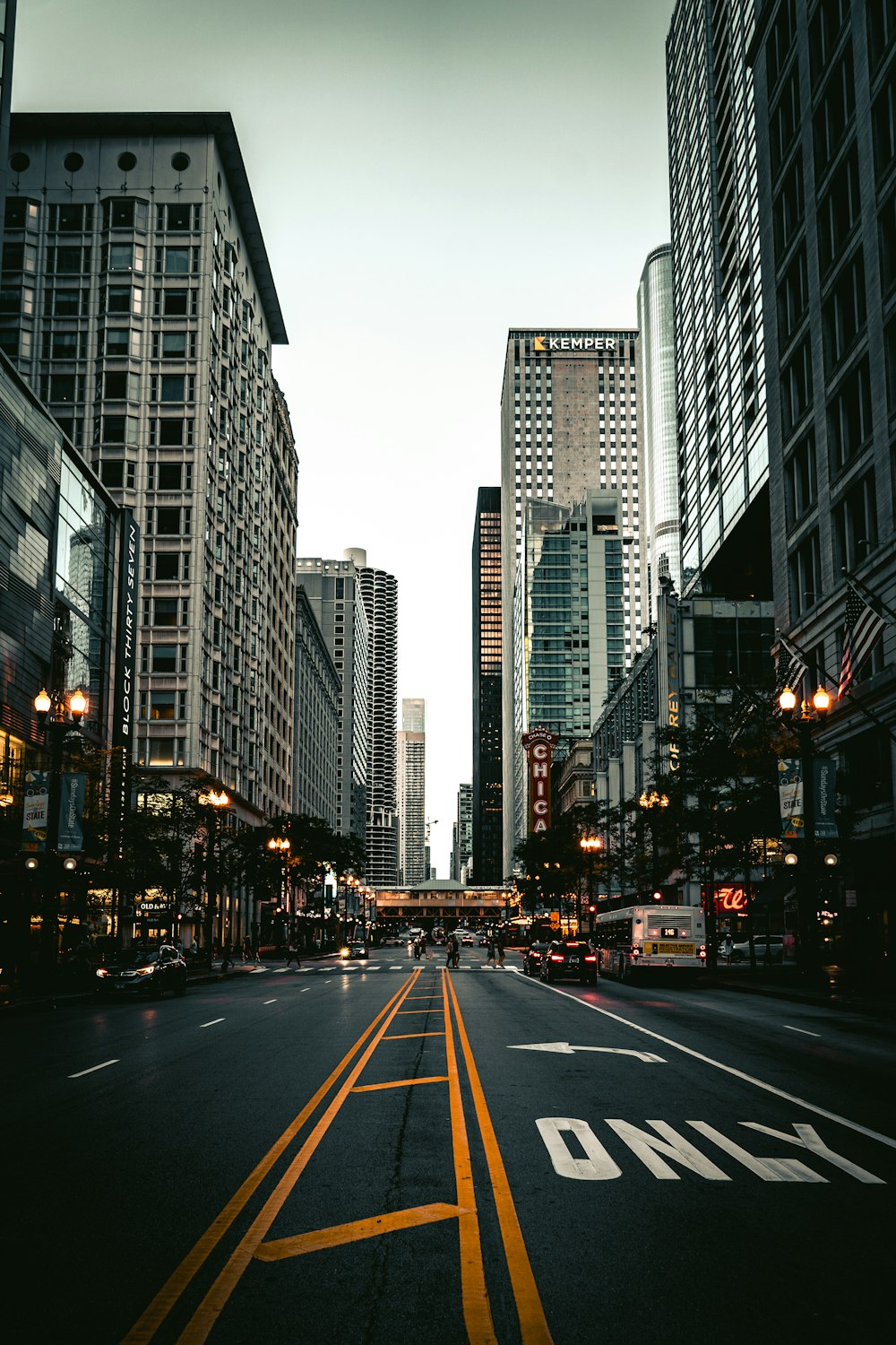 a city street lined with tall buildings and traffic