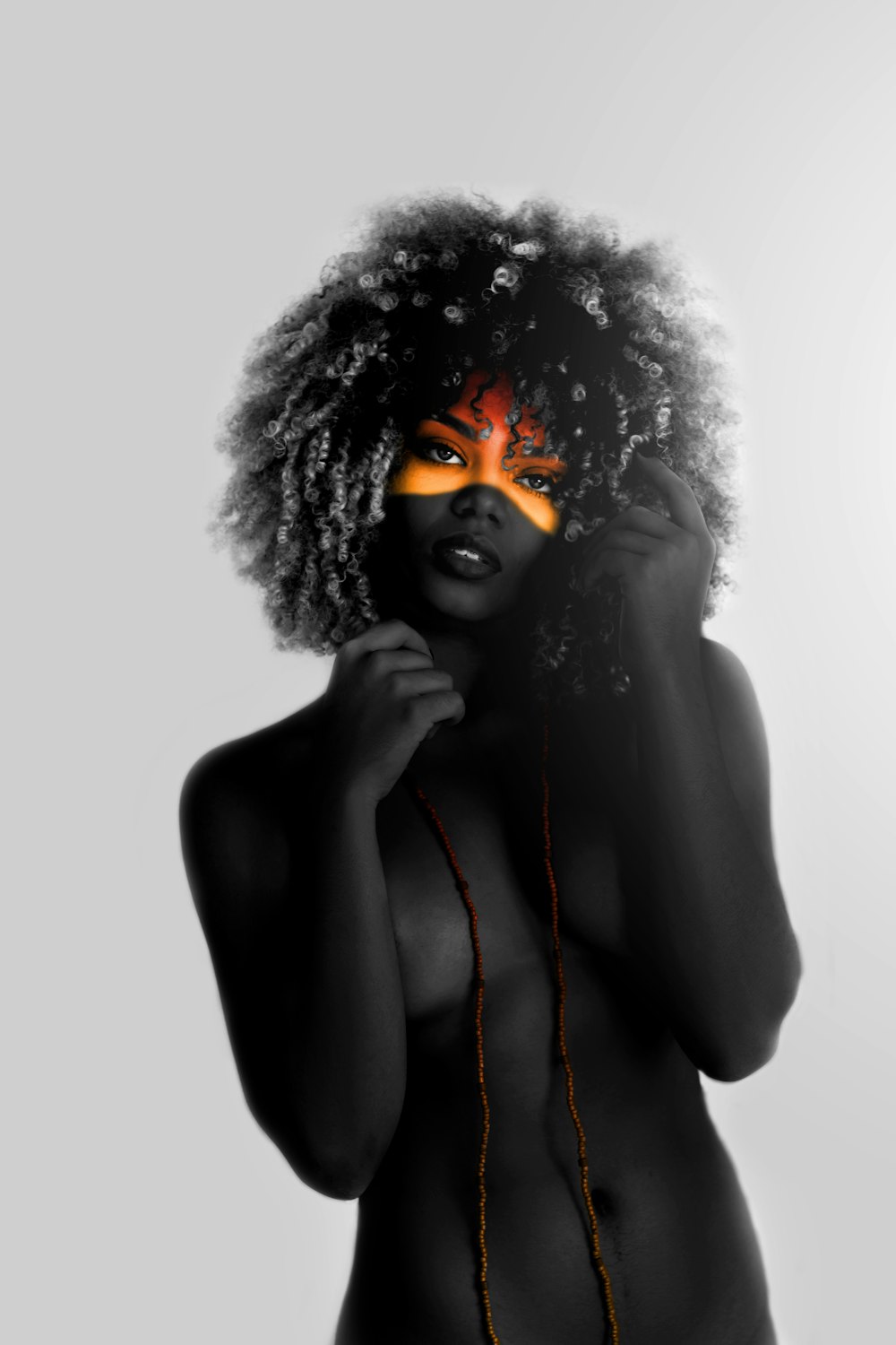 a woman with orange painted on her face