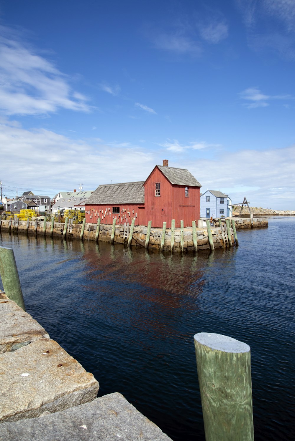 a red building sitting on top of a body of water