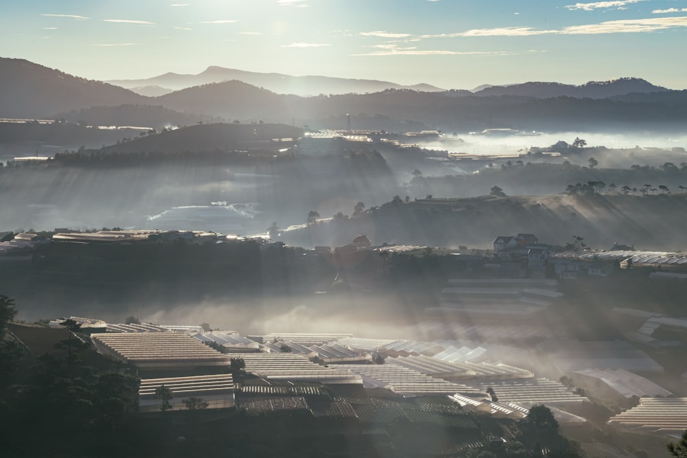 the sun shines through the clouds over a city