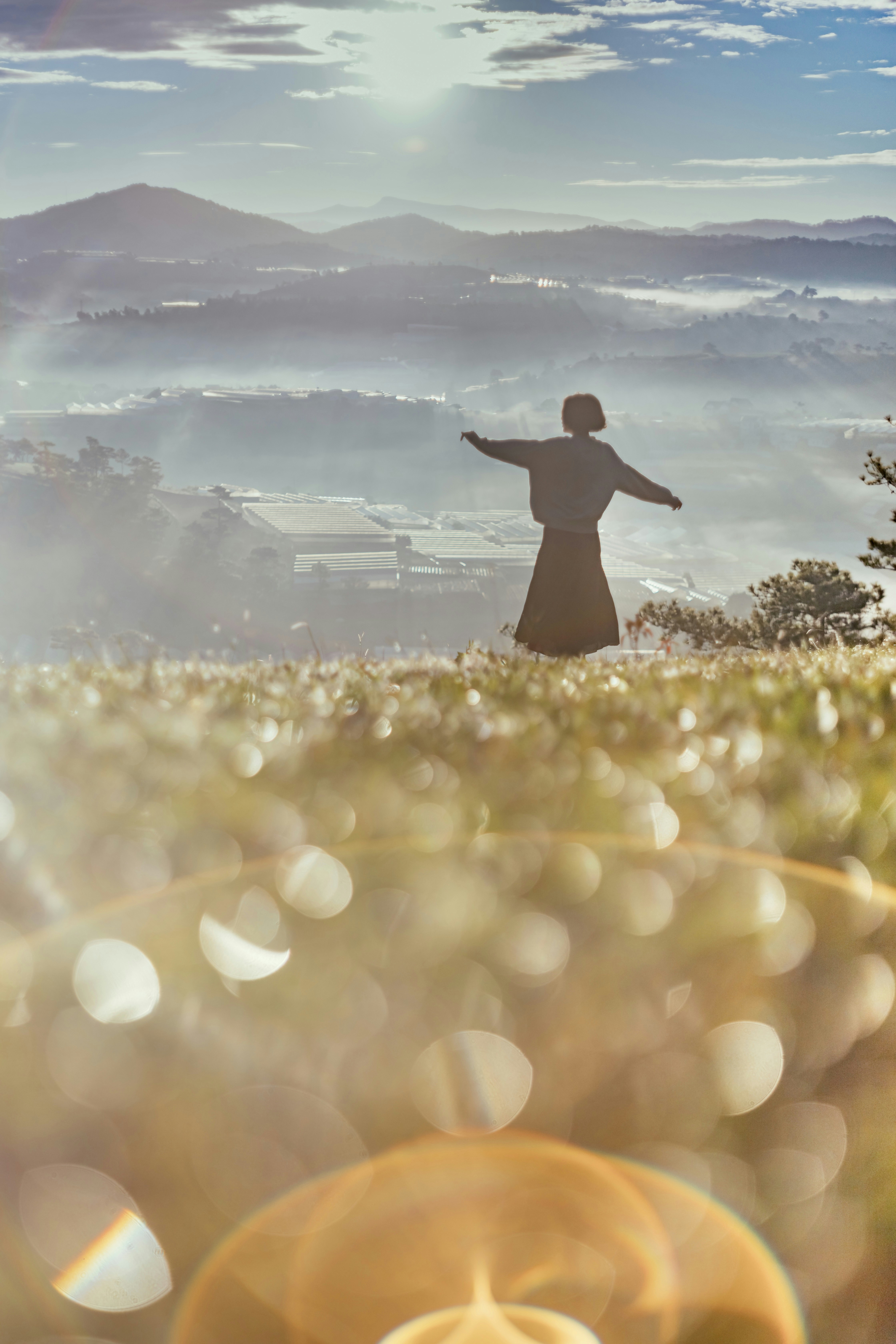 a person standing in a field with their arms outstretched