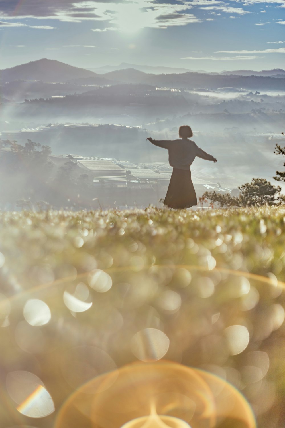 a person standing in a field with their arms outstretched