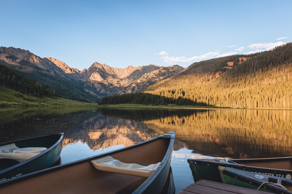 a couple of boats sitting on top of a lake