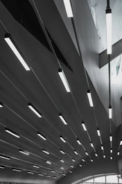 Linear kitchen ceiling lights illuminating a bright, airy kitchen.