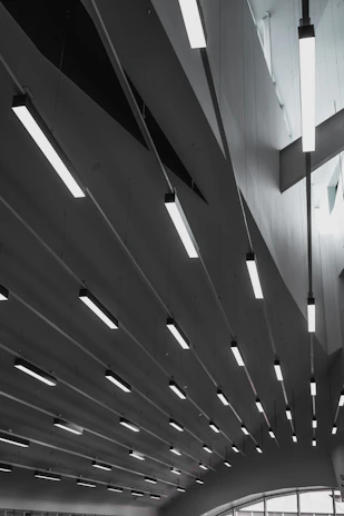 Linear kitchen ceiling lights illuminating a modern farmhouse kitchen.