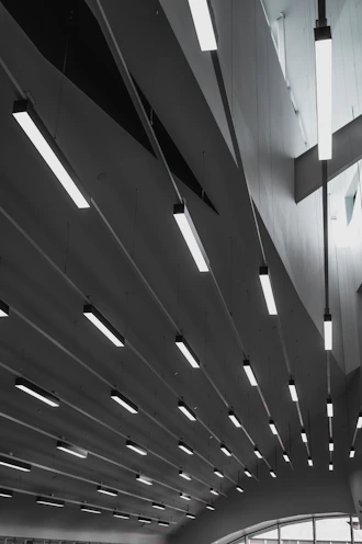 Linear kitchen ceiling lights illuminating a modern farmhouse kitchen.