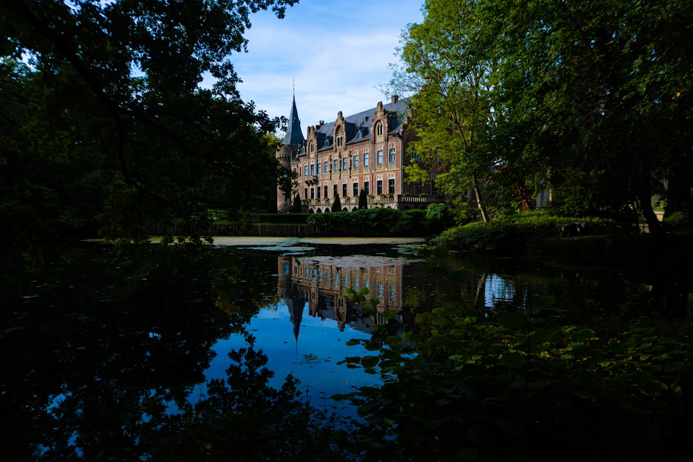 a large building with a pond in front of it