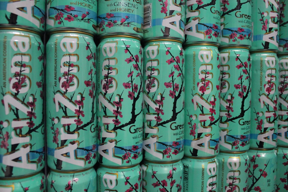 a large stack of tea cans with cherry blossoms on them