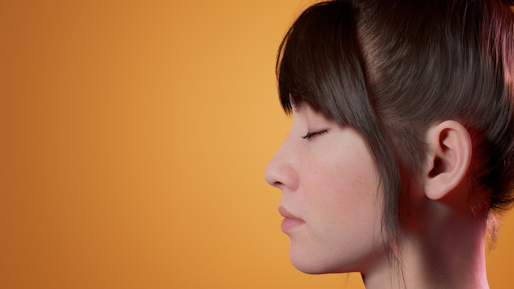 a woman with her eyes closed and her hair in a bun