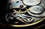 a close up of a watch face showing the gears