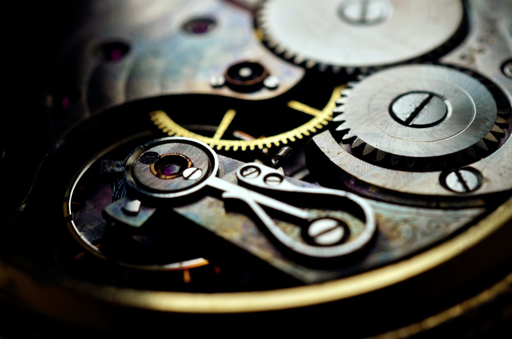 a close up of a watch face showing the gears