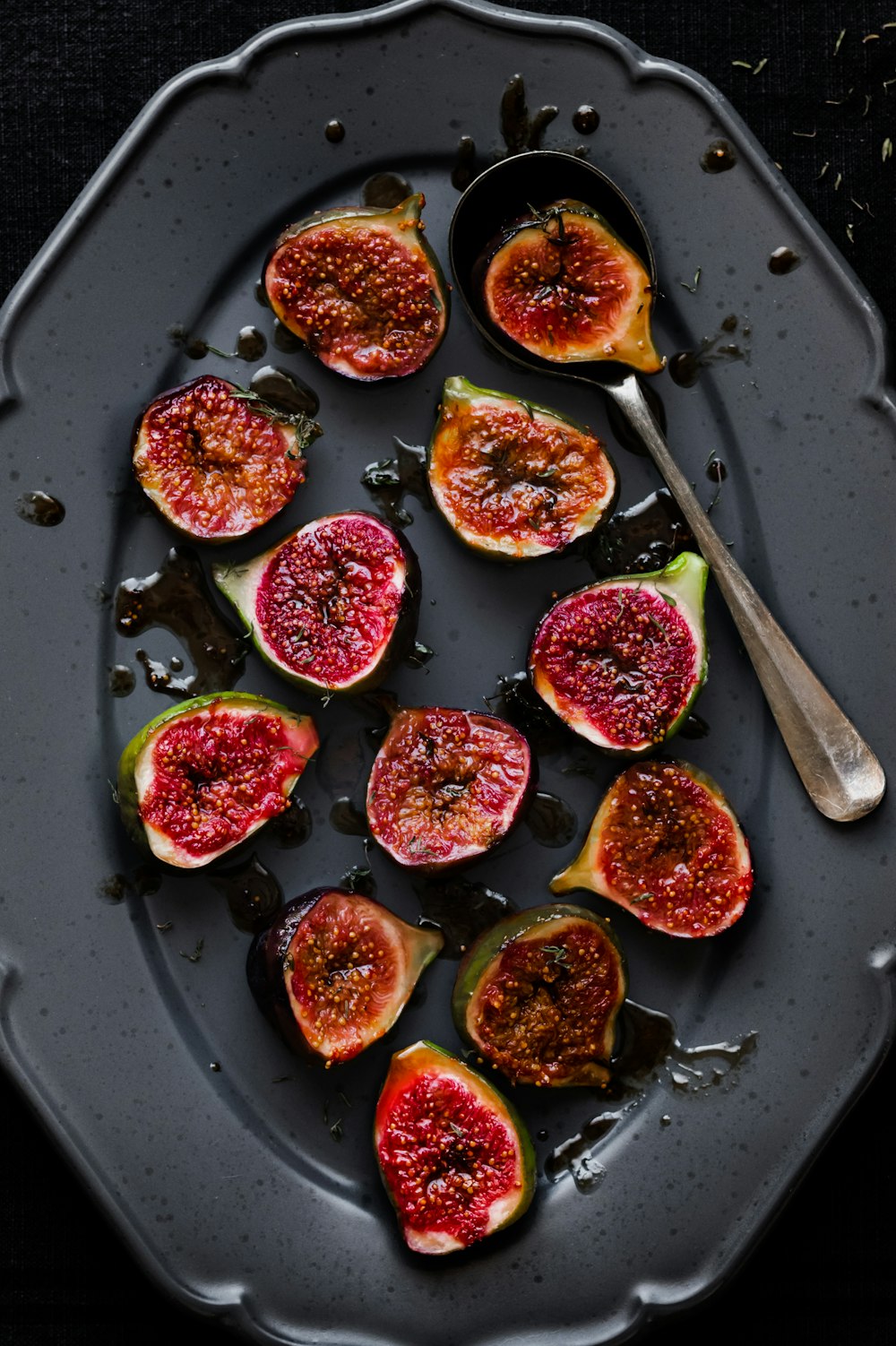 a plate with figs and a spoon on it