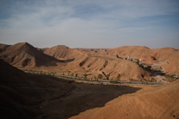 a view of a desert with a road going through it