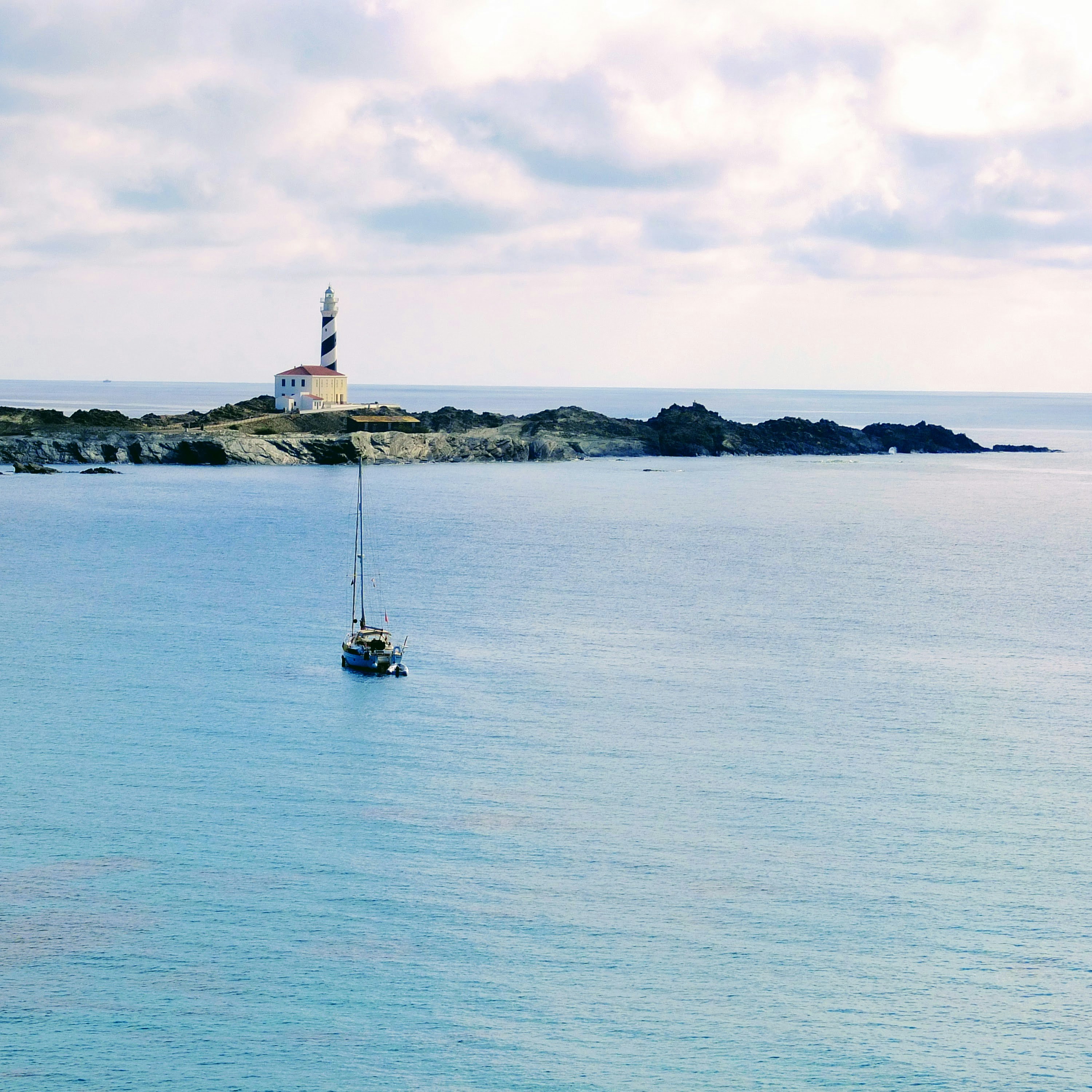 a sailboat in the middle of a body of water
