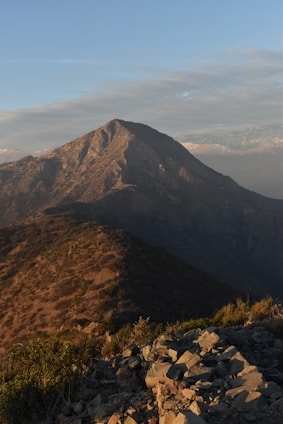 a view of a mountain with rocks and grass