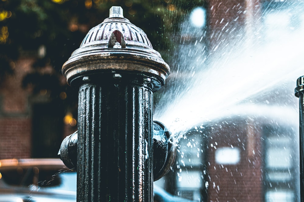 a fire hydrant spraying water on a city street