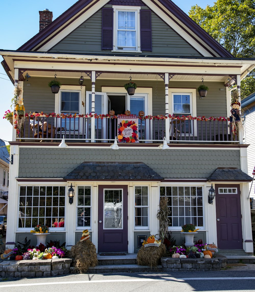 a two story house with a porch and balconies on the balconies