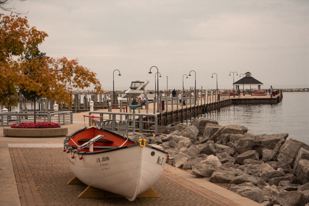 a boat sitting on the shore of a lake