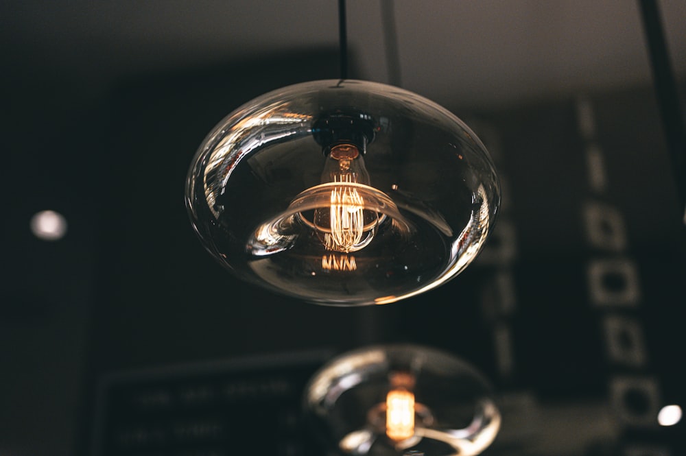 a clear light bulb hanging from a ceiling